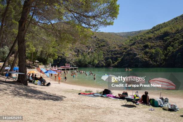 Several people spend the day at the Bolarque reservoir beach, August 20, in Guadalajara, Castilla La-Mancha, Spain. This natural tourist environment...