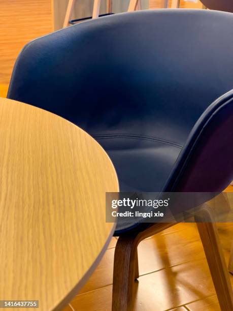 yellow wooden table and dark blue sofa - navy blue living room stock pictures, royalty-free photos & images