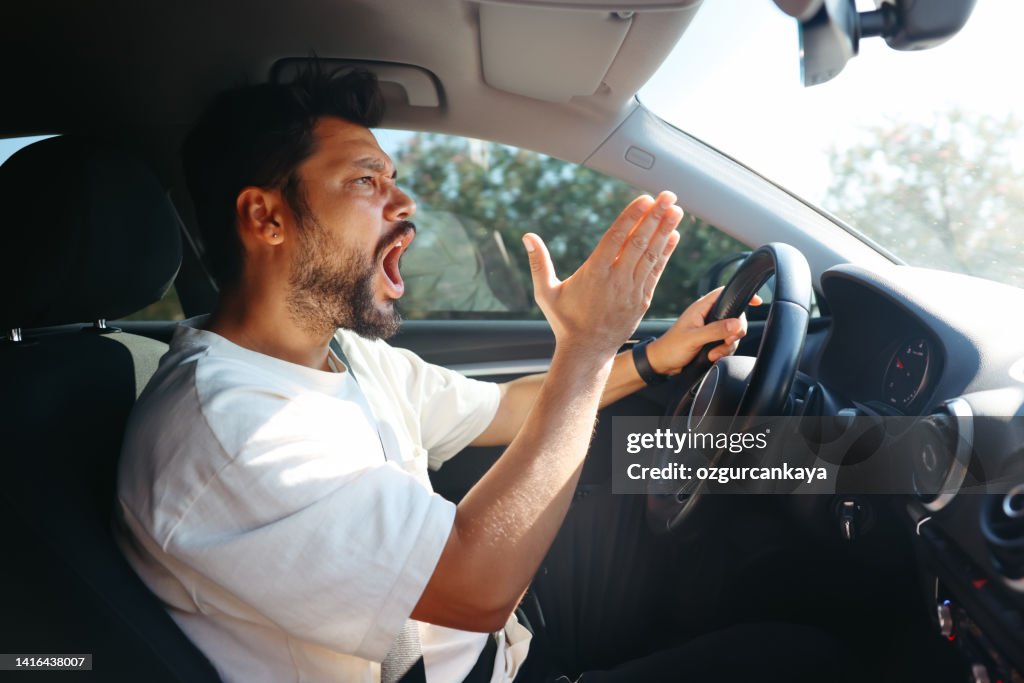 Young man getting angry on the road