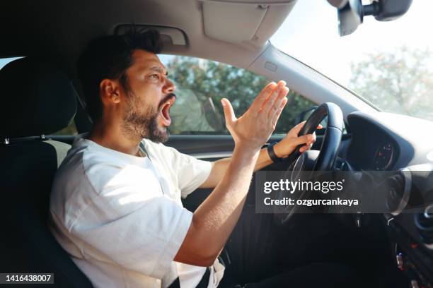 young man getting angry on the road - angry men stockfoto's en -beelden