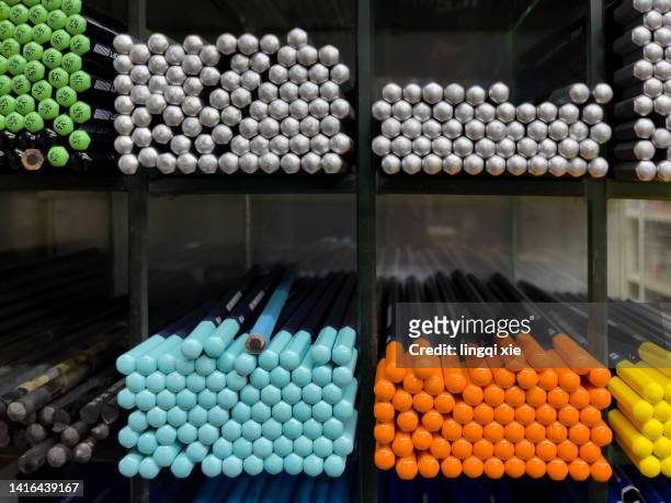 abstract pattern formed by various pens on a shelf - button craft foto e immagini stock
