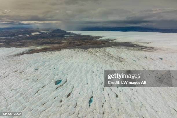 An aerial view of meltwater lakes formed at the Russell Glacier front, part of the Greenland ice sheet in Kangerlussuaq, Greenland, on August 16,...