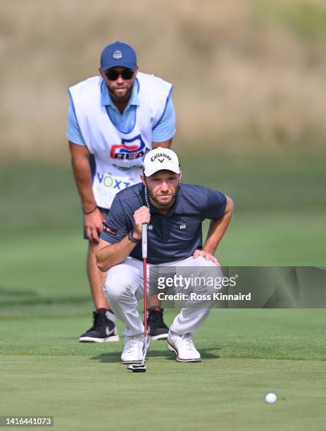 Maximilian Kieffer of Germany and his caddy line up a putt on the 13th hole during Day Four of the D+D Real Czech Masters at Albatross Golf Resort on...