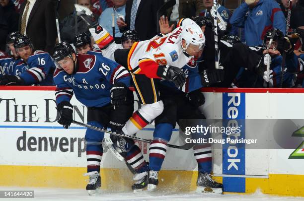 Jarome Iginla of the Calgary Flames is double teamed as Paul Stastny and Ryan Wilson of the Colorado Avalanche put on the squeeze at Pepsi Center on...