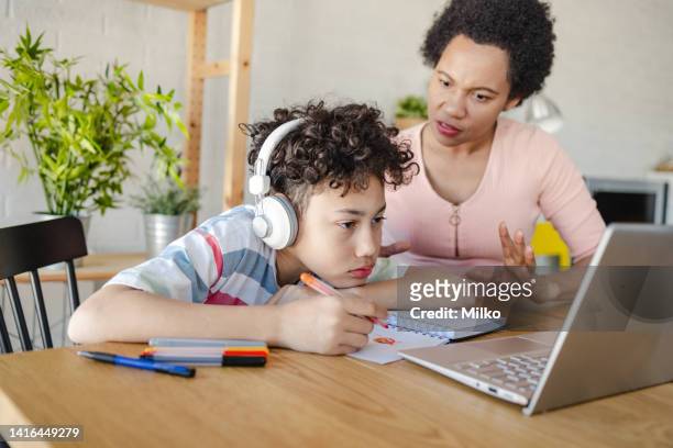 little boy is having learning difficulties and his mother is helping him to study for school - dyslexia stock pictures, royalty-free photos & images