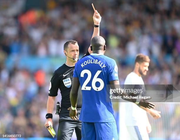 Kalidou Koulibaly of Chelsea is shown a red card by referee Stuart Atwell during the Premier League match between Leeds United and Chelsea FC at...