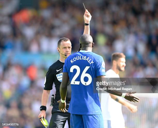 Kalidou Koulibaly of Chelsea is shown a red card by referee Stuart Atwell during the Premier League match between Leeds United and Chelsea FC at...