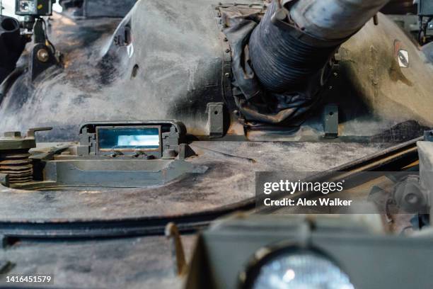 main gun of military tank with open drivers hatch - vehicle hatch stock pictures, royalty-free photos & images