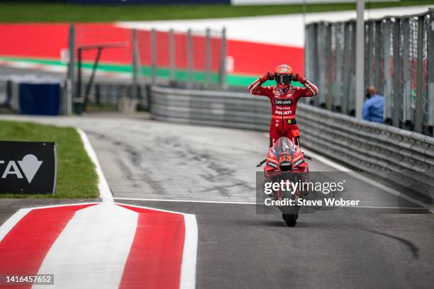 Francesco Bagnaia of Italy and Ducati Lenovo Team stands an his bike and rolls through the pitlane after his race win during the race of the...