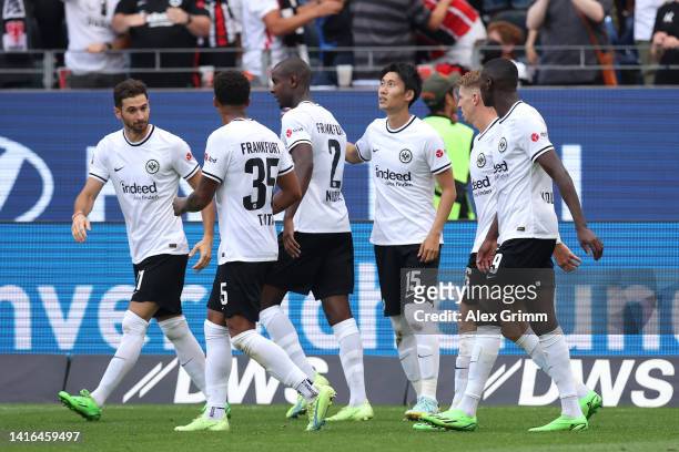 Daichi Kamada of Eintracht Frankfurt celebrates with teammates after scoring their team's first goal during the Bundesliga match between Eintracht...