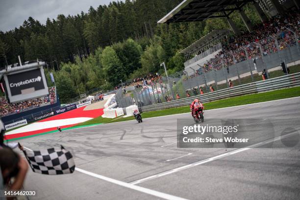 Francesco Bagnaia of Italy and Ducati Lenovo Team crosses the line in font of Fabio Quartararo of France and Monster Energy Yamaha MotoGP and wins...