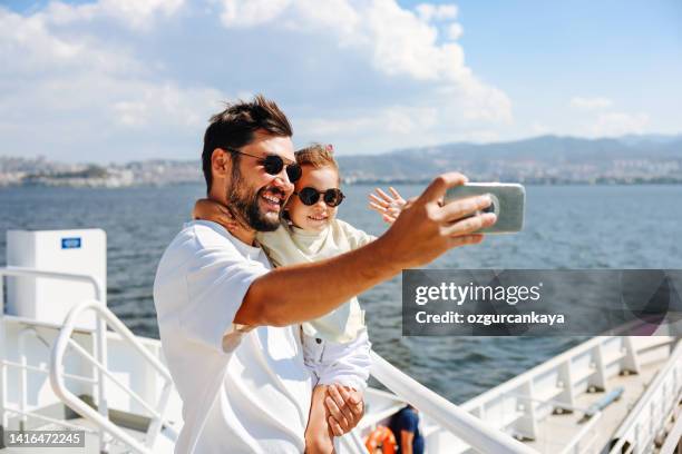 father with daughter taking selfie - ferry passenger stock pictures, royalty-free photos & images