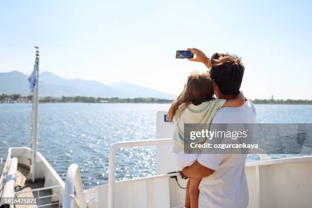 father with daughter taking selfie - cruise ship family stock pictures, royalty-free photos & images