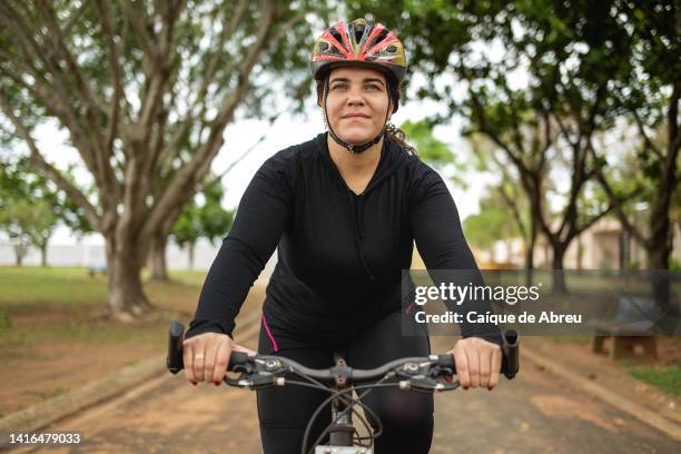 cycling and connecting with the nature at a park - adult riding bike through park stock pictures, royalty-free photos & images