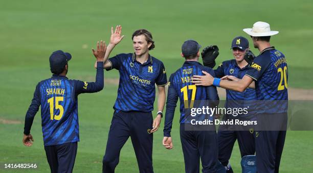 George Garrett of Warwickshire celebrates with team mates after taking the wicket of Graham Clark during the Royal London Cup match between...