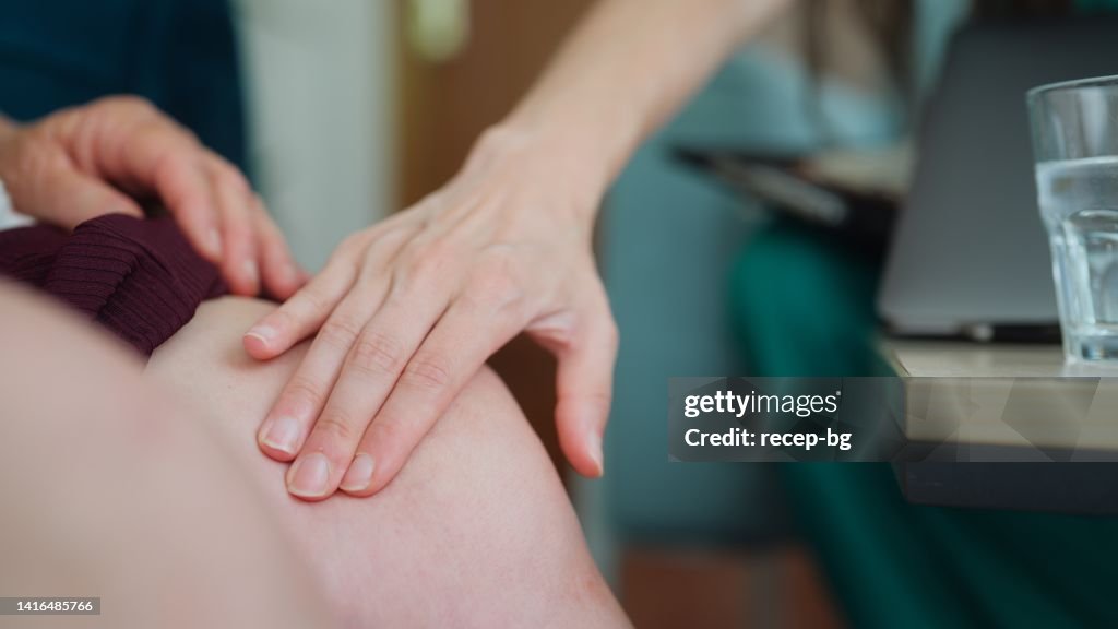 Ärztin, die ihre ältere Patientin in ihrem Haus zur medizinischen Untersuchung besucht