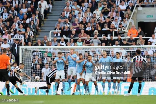 Kieran Trippier of Newcastle United scores their side's third goal from a free kick as Ederson of Manchester City attempts to make a save during the...