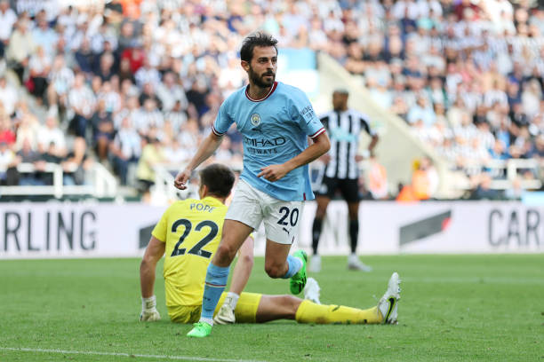 Bernardo Silva of Manchester City celebrates scoring their side's third goal as Nick Pope of Newcastle United reacts during the Premier League match...