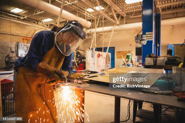 young teenage woman welding - student welder stock pictures, royalty-free photos & images