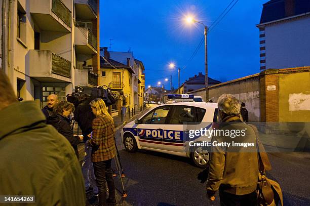 Members of the media gather at the end of a road sealed off by police during an operation to arrest 23-year-old Mohammed Merah 23, the man suspected...