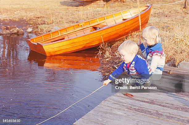 children on jetty pretending to fish - 1967 stock pictures, royalty-free photos & images