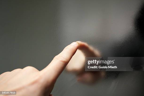 finger touching steamy mirror. - mirror steam stockfoto's en -beelden