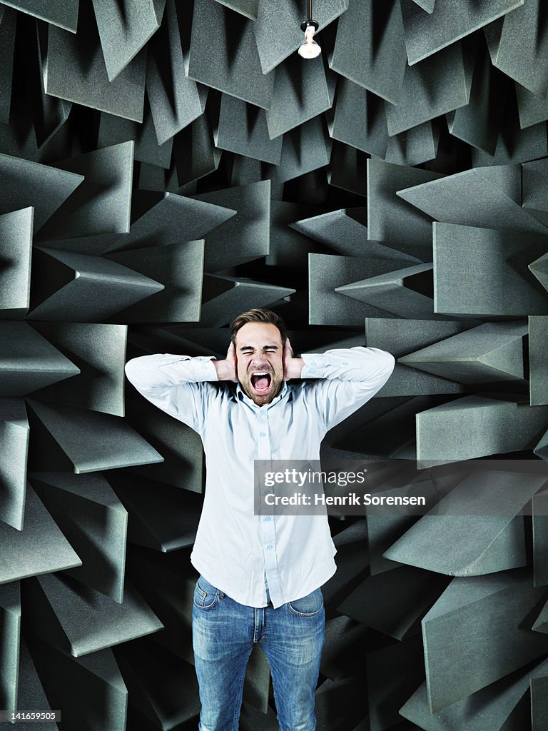 Young man in anechoic chamber