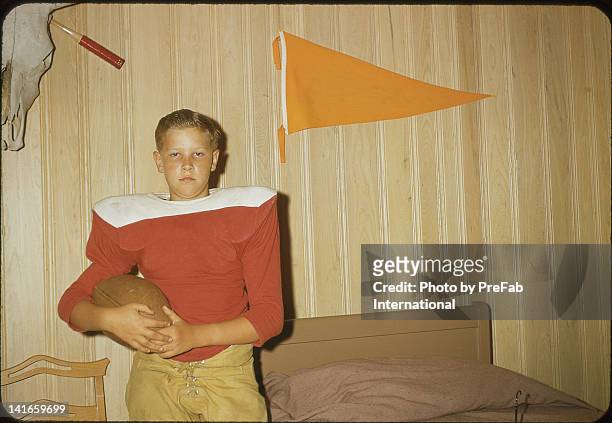 boy holding football - 1950s bedroom stock pictures, royalty-free photos & images