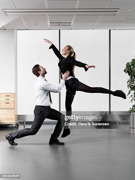 business couple dancing in office - ballet black and white stock pictures, royalty-free photos & images