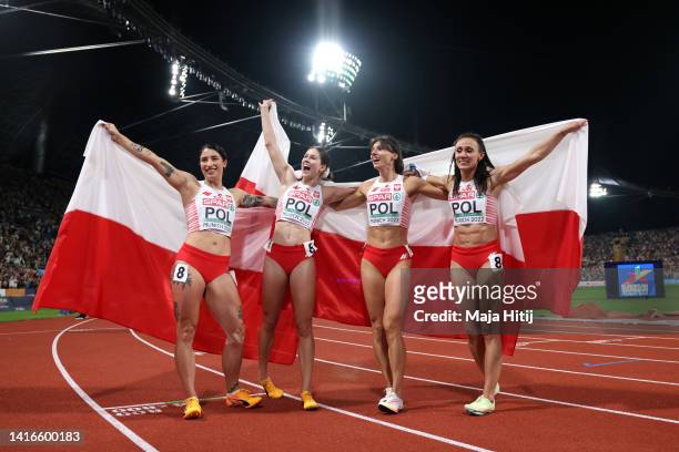 Silver medalists Anna Kielbasinska, Marika Popowicz-Drapala, Ewa Swoboda and Pia Skrzyszowska of Poland celebrate following the Women's 4 x 100m...