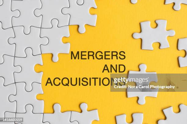 mergers and acquisitions concept jigsaw puzzle - mergers growth stock pictures, royalty-free photos & images