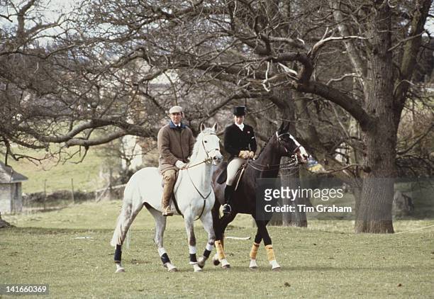 Princess Anne, the Princess Royal, and her husband Mark Phillips out riding at the Badminton Horse Trials in Gloucestershire, circa 1980. Anne is...