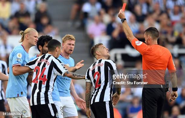 Kieran Trippier of Newcastle United is shown a red card by referee Jarred Gillett which is later overturned to a yellow card during the Premier...