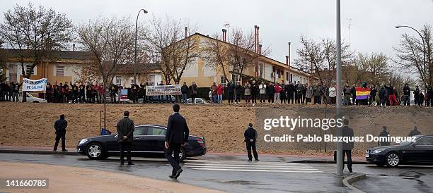 The car of King Juan Carlos of Spain passes by a demonstration after the 'Rey Juan Carlos' University Hospital inauguration on March 21, 2012 in...