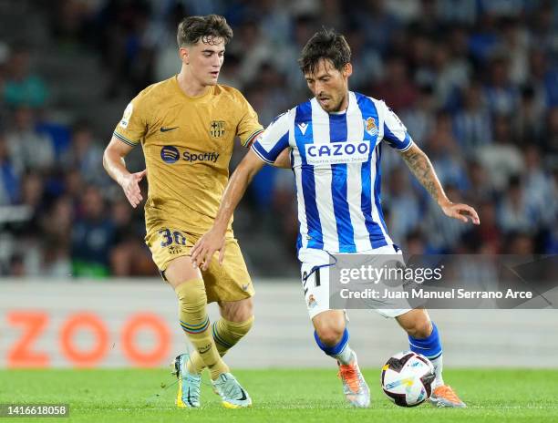 David Silva of Real Sociedad battles for possession with Gavi of FC Barcelona during the LaLiga Santander match between Real Sociedad and FC...