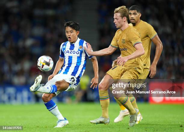 Takefusa Kubo of Real Sociedad battles for possession with Frenkie de Jong of FC Barcelona during the LaLiga Santander match between Real Sociedad...