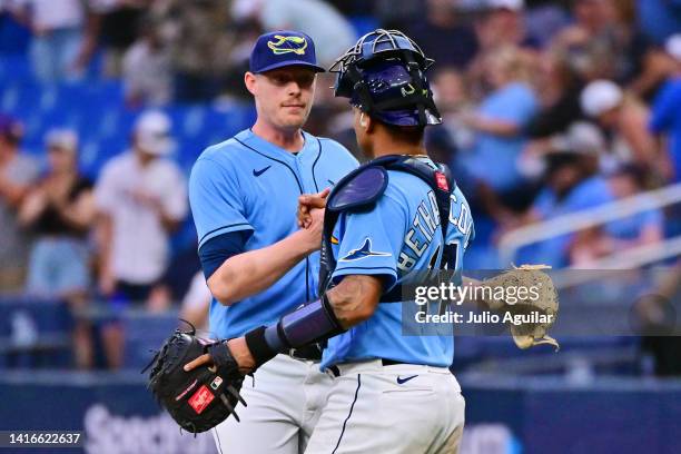 Pete Fairbanks of the Tampa Bay Rays celebrates with Christian Bethancourt after defeating the Kansas City Royals 3-2 at Tropicana Field on August...