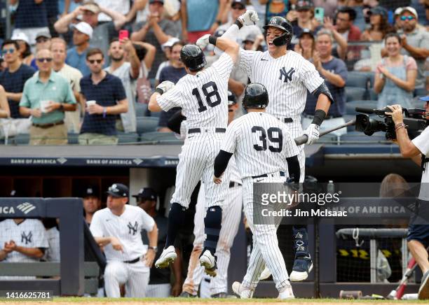 Andrew Benintendi of the New York Yankees celebrates his seventh inning two run home run against the Toronto Blue Jays with teammates Aaron Judge and...