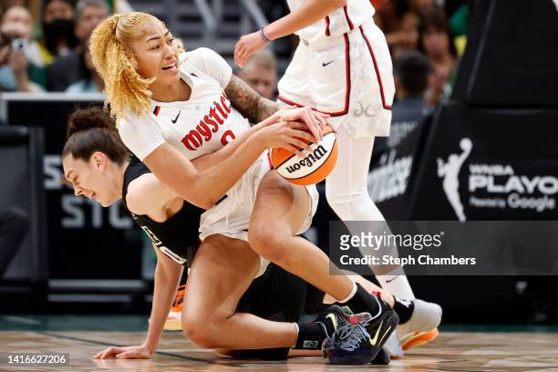 Breanna Stewart of the Seattle Storm and Shakira Austin of the Washington Mystics battle for a loose ball during the first quarter in Round 1 Game 2...