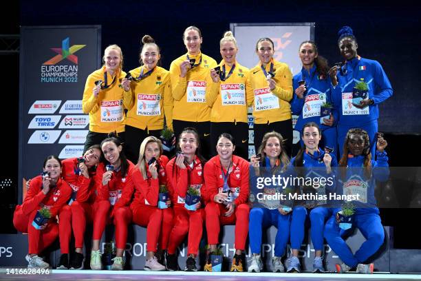 Gold medalists of Germany, Silver medalists of Poland and Bronze medalists of Italy celebrate on the podium during the Women's 4 x 100m medal...