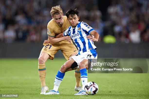 Frankie de Jong of FC Barcelona competes for the ball with Takefusa Kubo of Real Sociedad during the La Liga Santander match between Real Sociedad...