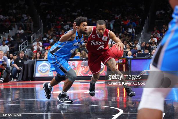 Isaiah Briscoe of the Trilogy drives against Glen Rice Jr. #41 of the Power during the BIG3 Championship at State Farm Arena on August 21, 2022 in...