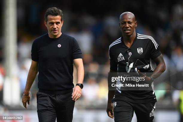 Fulham manager Marco Silva and assistant Luis Boa Morte walk to the dug outs ahead of the Premier League match between Fulham FC and Brentford FC at...