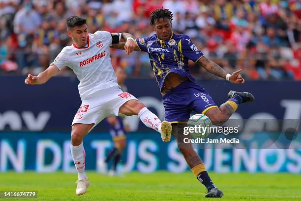 Claudio Baeza of Toluca fights for the ball with Abel Hernandez of San Luis during the 10th round match between Atletico San Luis and Toluca as part...