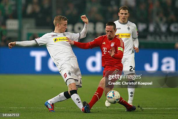 Oscar Wendt of Moenchengladbach challenges Franck Ribery of Bayern during the DFB Cup semi final match between Borussia Moenchengladbach and FC...