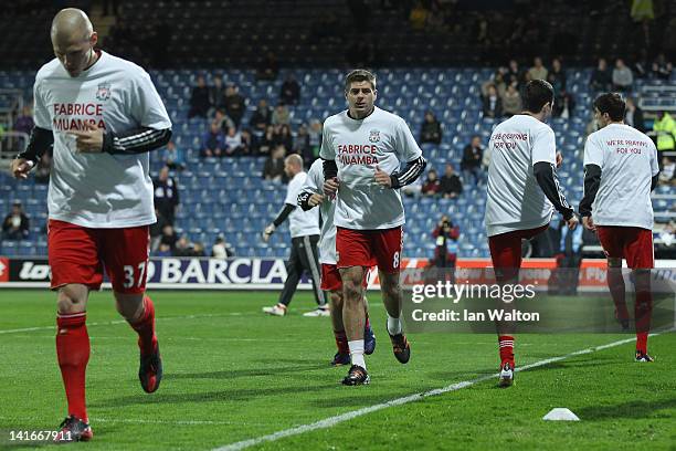 Liverpool players wear t-shirts in support of Bolton Wanderers' English midfielder Fabrice Muamba prior to the Barclays Premier League match between...