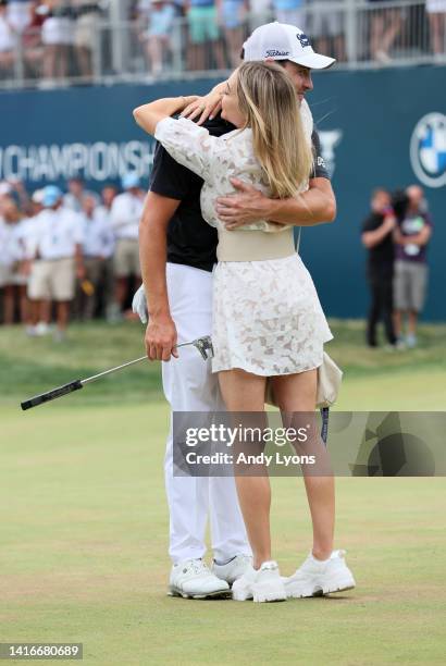 Patrick Cantlay of the United States reacts with his wife Nikki Guidish after putting in to win on the 18th green during the final round of the BMW...