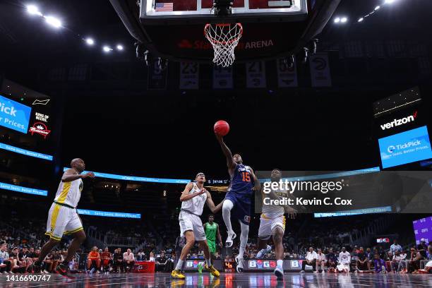 Mario Chalmers of 3's Company lays up against Donte Green of the Killer 3's during the All-Star game prior to the BIG3 Championship at State Farm...