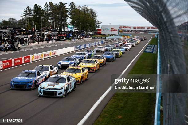 Kyle Larson, driver of the HendrickCars.com Chevrolet, and Chase Elliott, driver of the Kelley Blue Book Chevrolet, lead the field during the NASCAR...