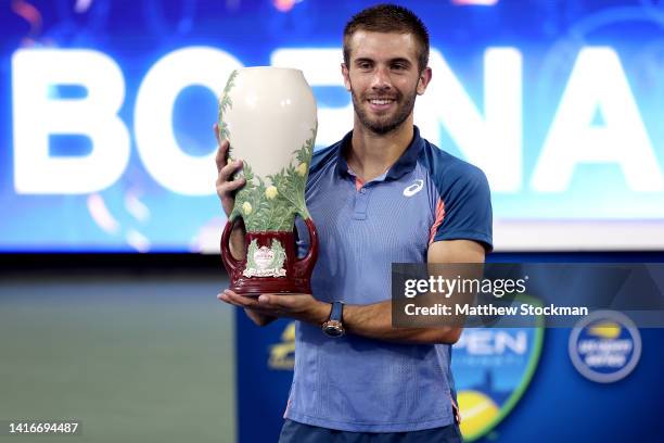 Borna Cric of Croatia poses for photographers after defeating Stefanos Tsitsipas of Greece during the men's final of the Western & Southern Open at...